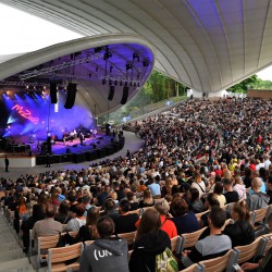 obrazek przestawia Amfiteatr w Koszalinie pełen publiczności podczas występu na scenie - widok od wewnątrz, zdjęcie w kolorze wykonane z górnych stopni amfiteatru