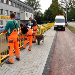 Wyremontowana droga rowerowa przy ul. Morskiej. Na zdjęciu widać trzech pracowników ubranych w pomarańczowe stroje robocze.