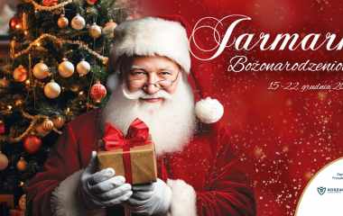 Grafika przedstawia postać Świętego Mikołaja trzymającego pudełko z prezentem na tle choinki